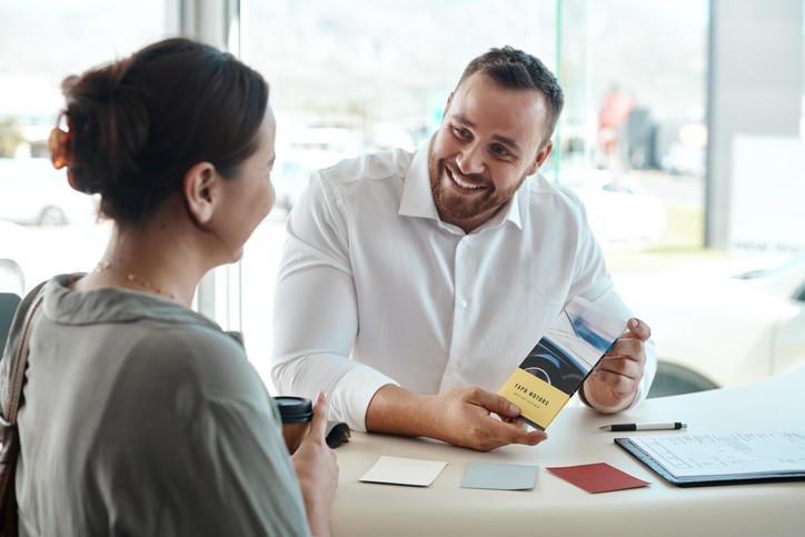 Man showing a POS Handout to a potential customer